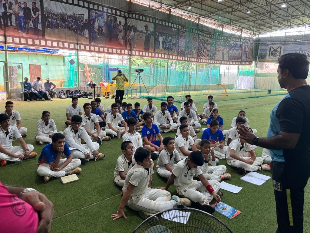 Group of Cricket Players Listening to an Instructor