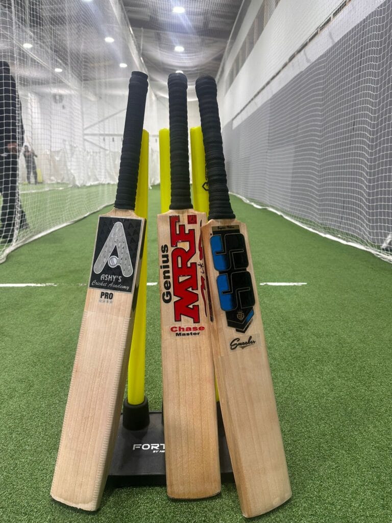 Cricket Bats Resting on Wickets